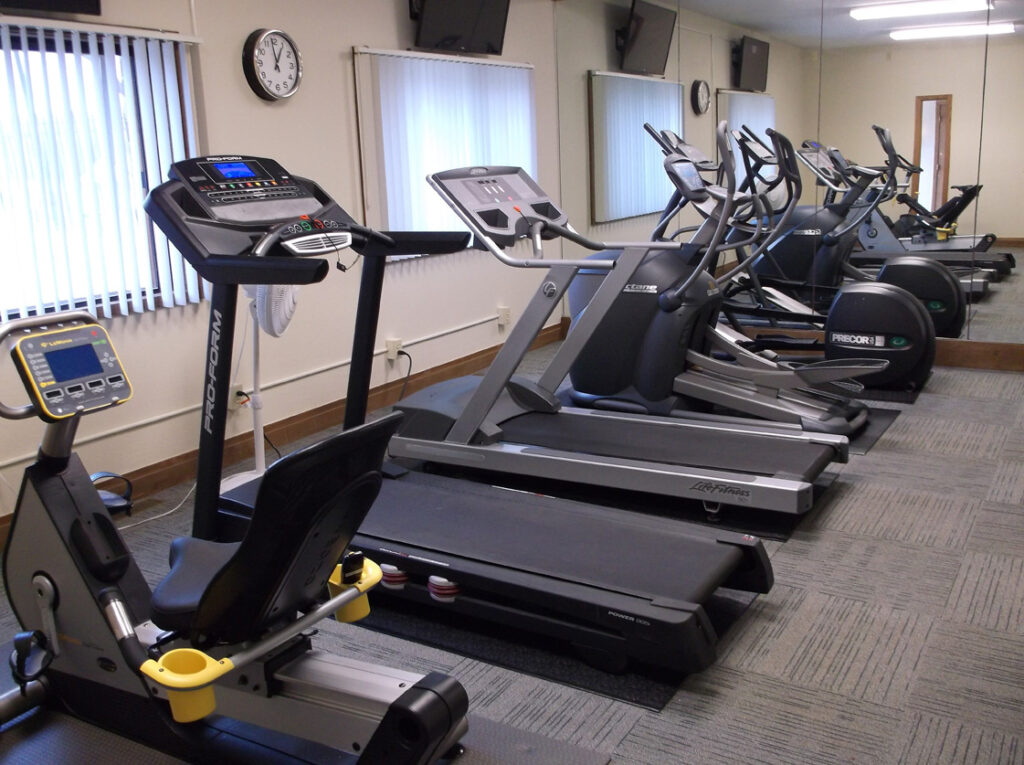 Fitness center with aerobic, weight, yoga equipment, and treadmills. 